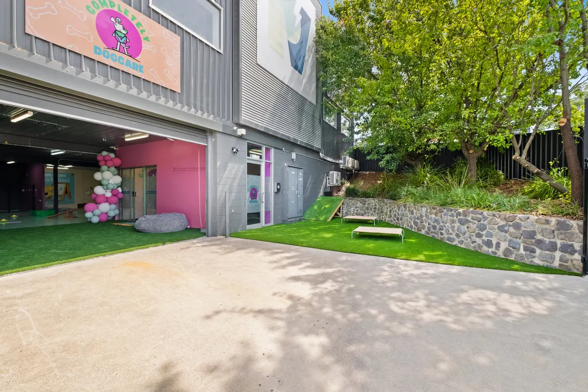 The front of Completely Dogcare with its green yard